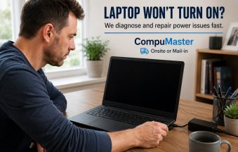 Man reconnecting the charger to a laptop with a black screen while trying to diagnose why it won't turn on.